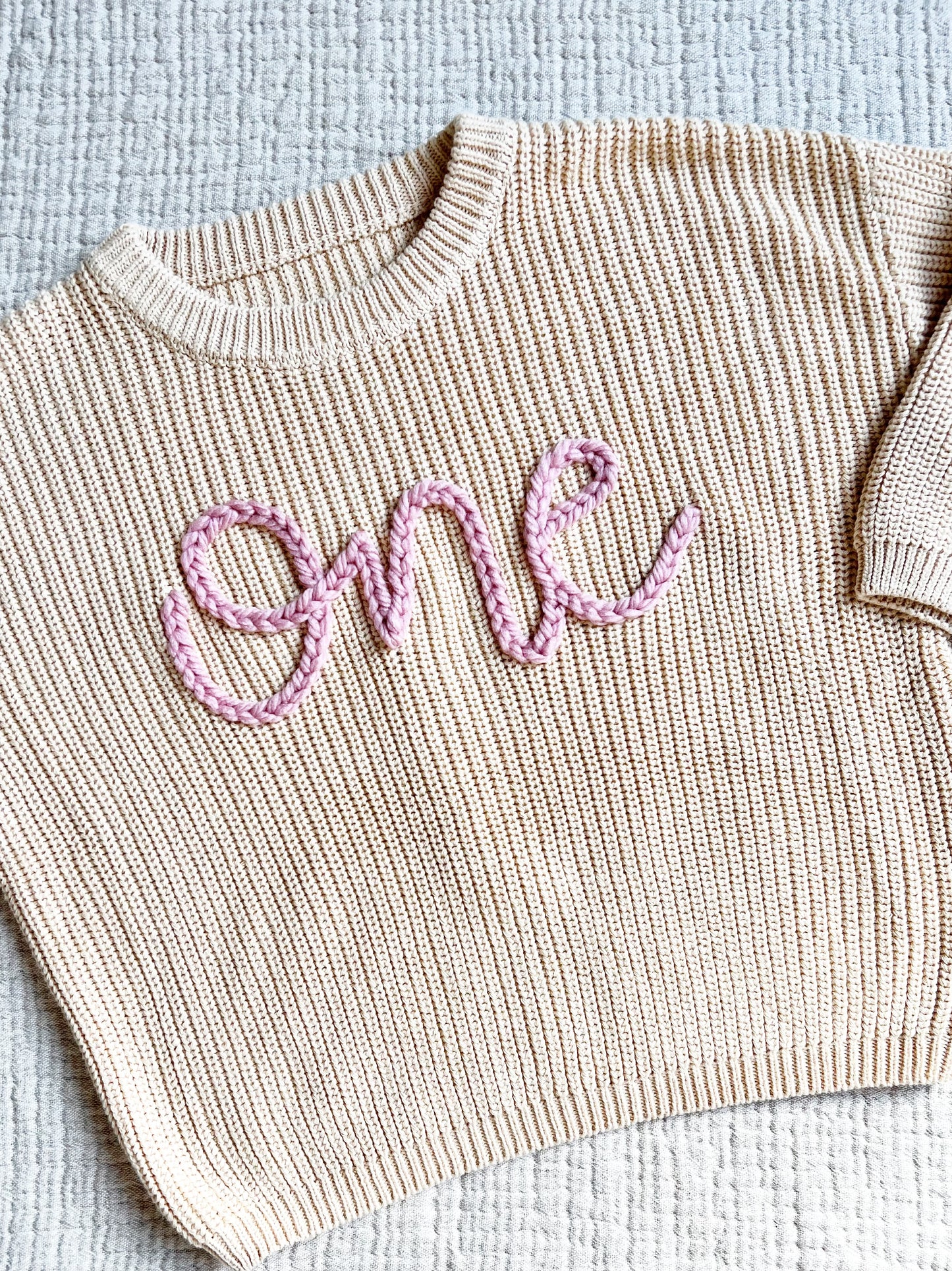 "ONE" EMBROIDERED SWEATER